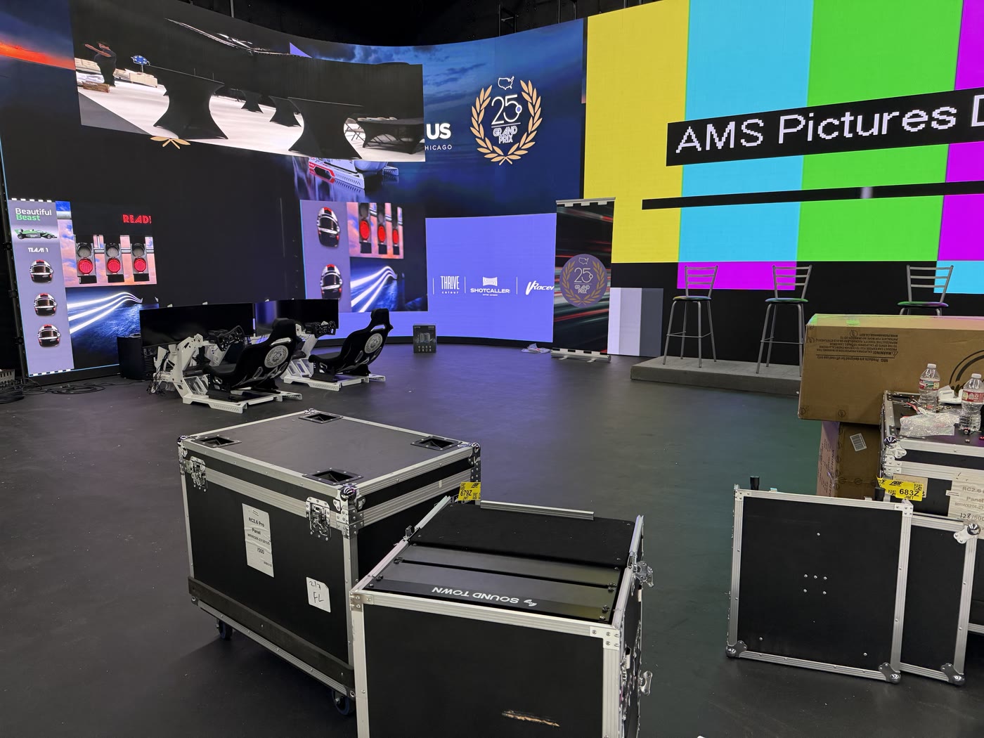 LED stage with simulators and flight cases at a C2B production